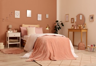 Photo of Teenage girl's bedroom interior with stylish furniture and beautiful decor elements