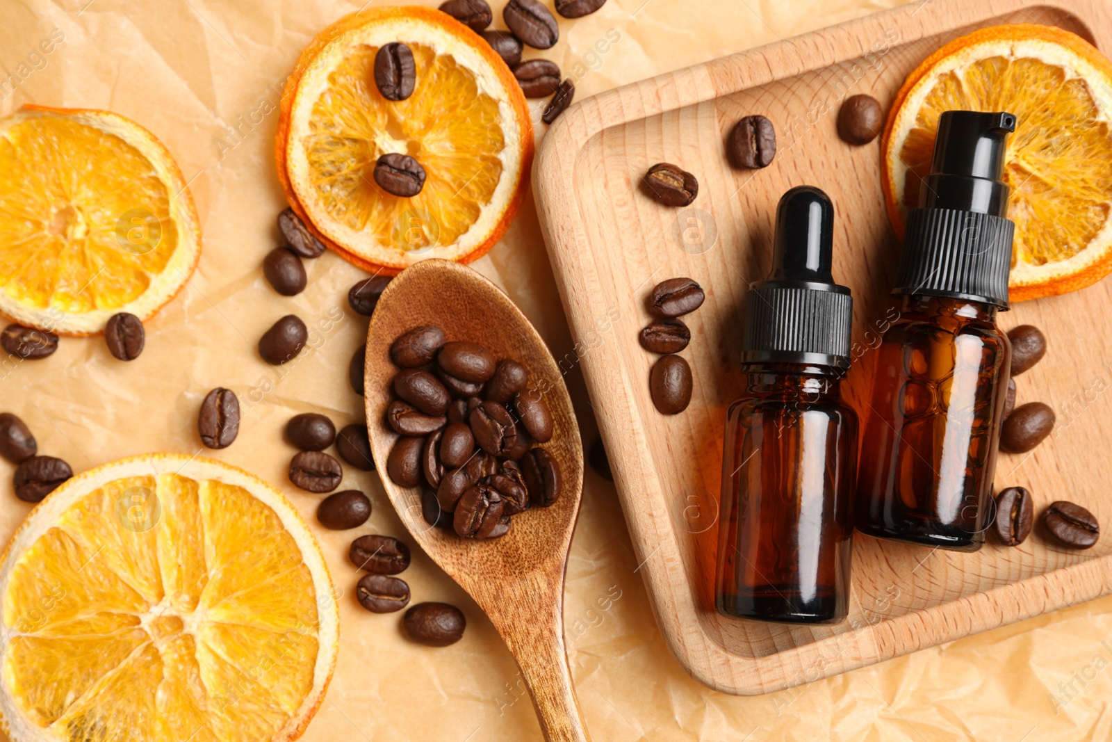 Photo of Flat lay composition with bottles of organic cosmetic products, coffee beans and dried orange slices on parchment paper