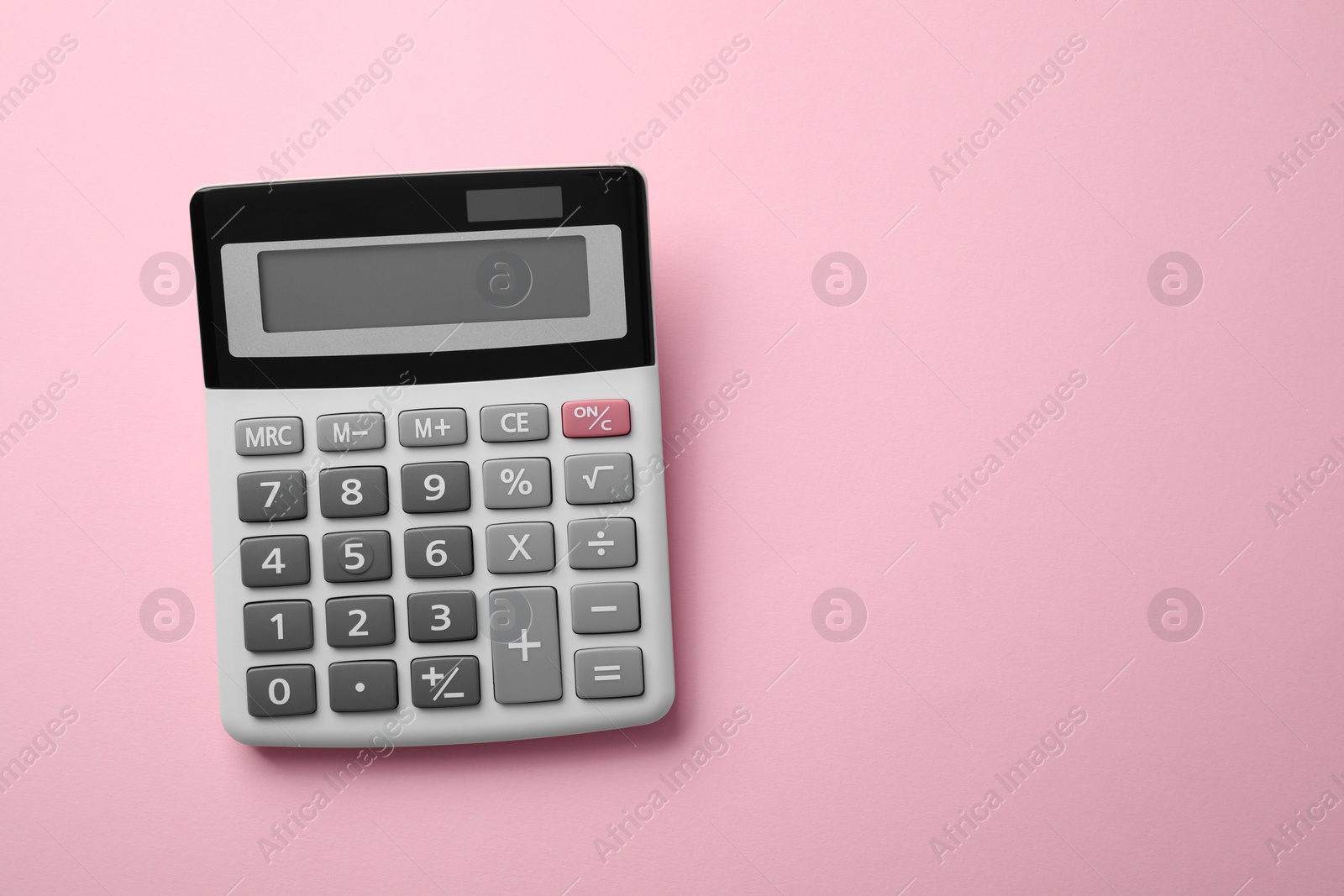 Photo of Calculator on pink background, top view. Space for text