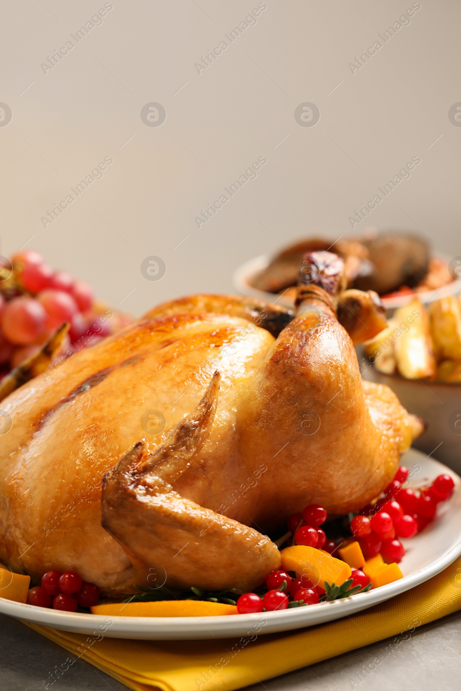 Photo of Traditional Thanksgiving day feast with delicious cooked turkey and other seasonal dishes served on light table, closeup