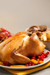 Photo of Traditional Thanksgiving day feast with delicious cooked turkey and other seasonal dishes served on light table, closeup