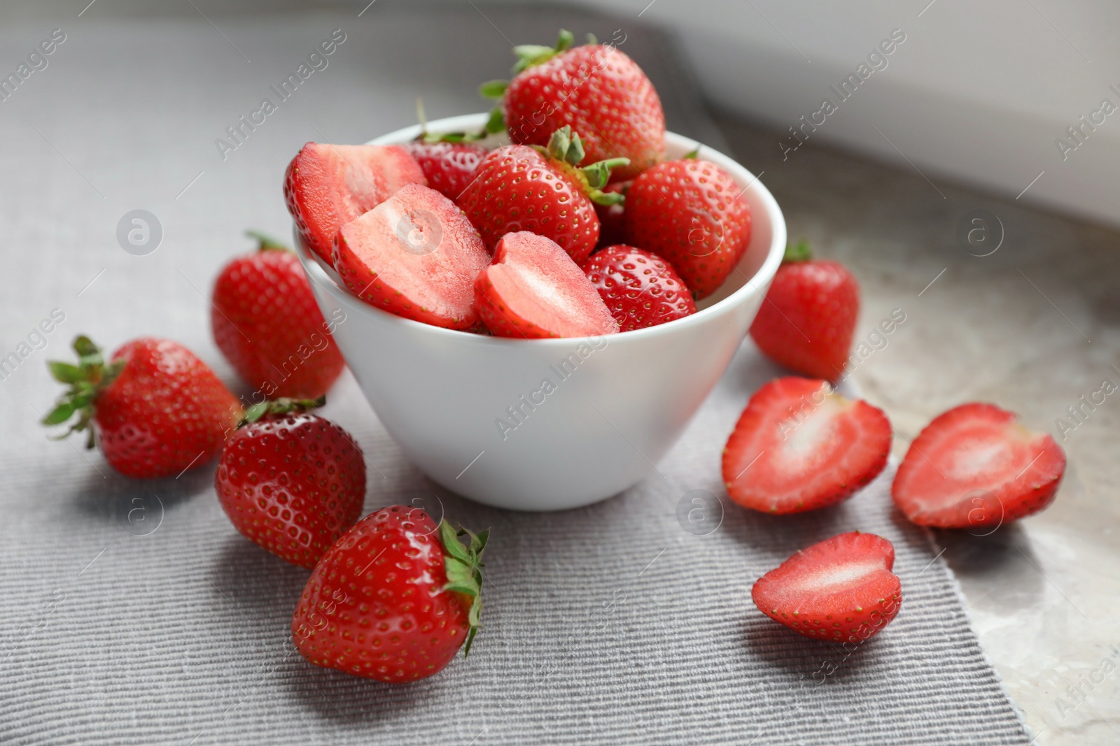 Photo of Whole and cut fresh juicy strawberries on table