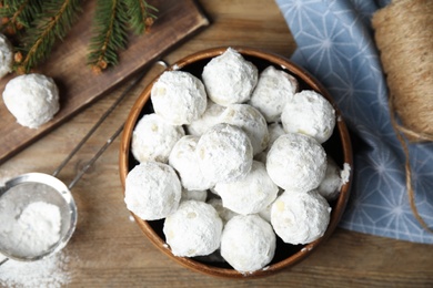 Photo of Flat lay composition with Christmas snowball cookies on wooden table