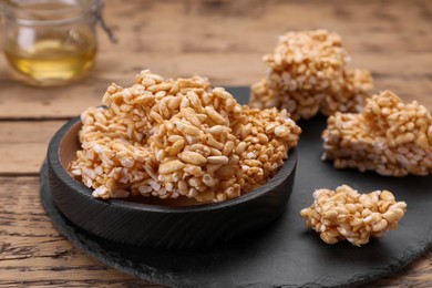 Photo of Puffed rice pieces (kozinaki) on wooden table, closeup