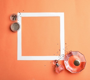 Photo of Flat lay composition with beauty accessories and space for text on coral background