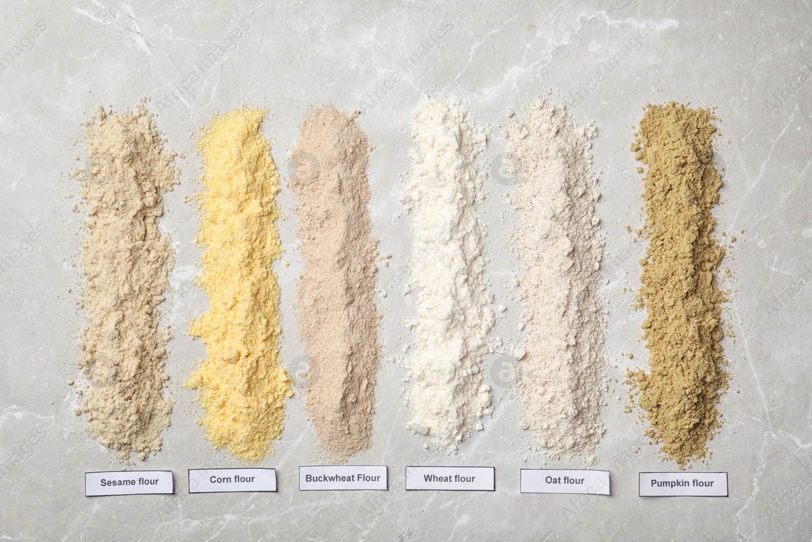 Photo of Composition with different types of flour on light background