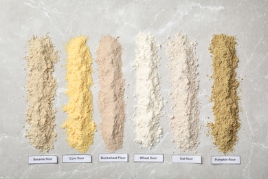 Composition with different types of flour on light background