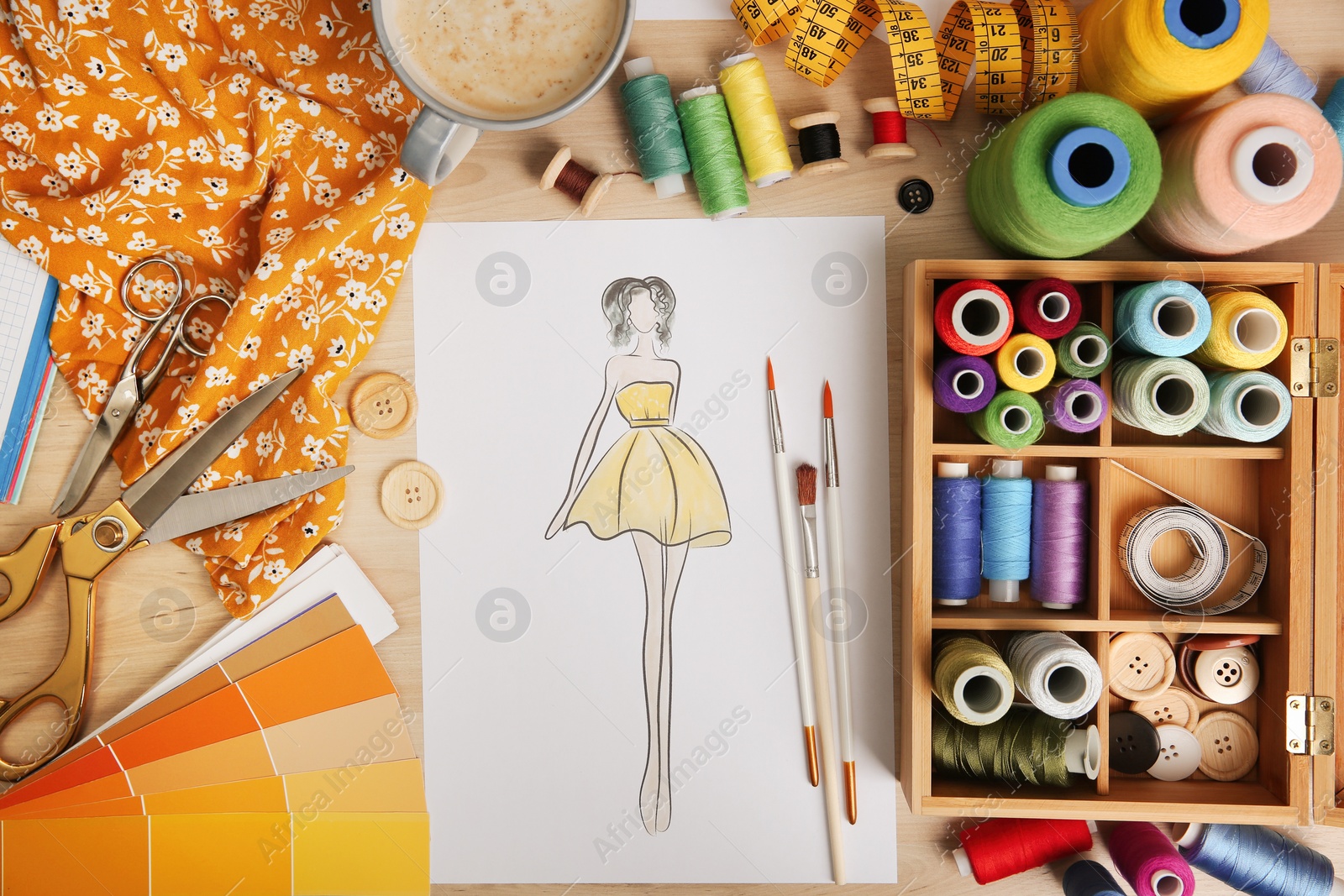 Photo of Sketch of fashion dress and thread supplies at designer's workplace, flat lay