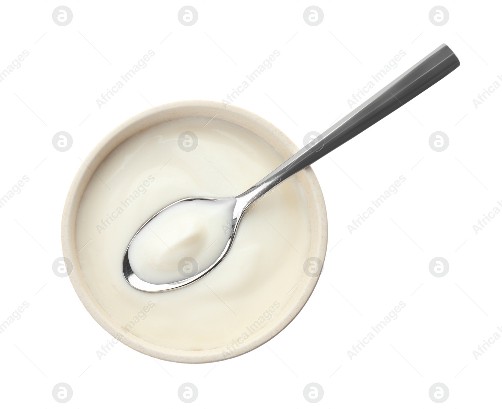 Photo of Bowl with spoon and yummy yogurt on white background