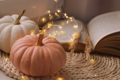 Photo of Pumpkins and book on wicker mat indoors