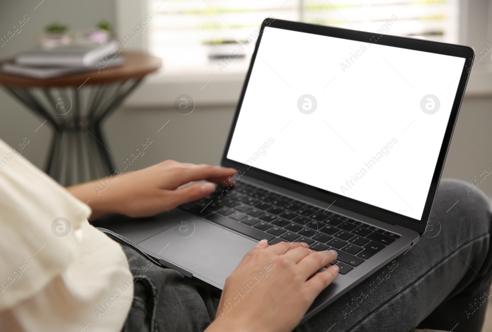 Photo of Woman working with modern laptop indoors, closeup. Space for design