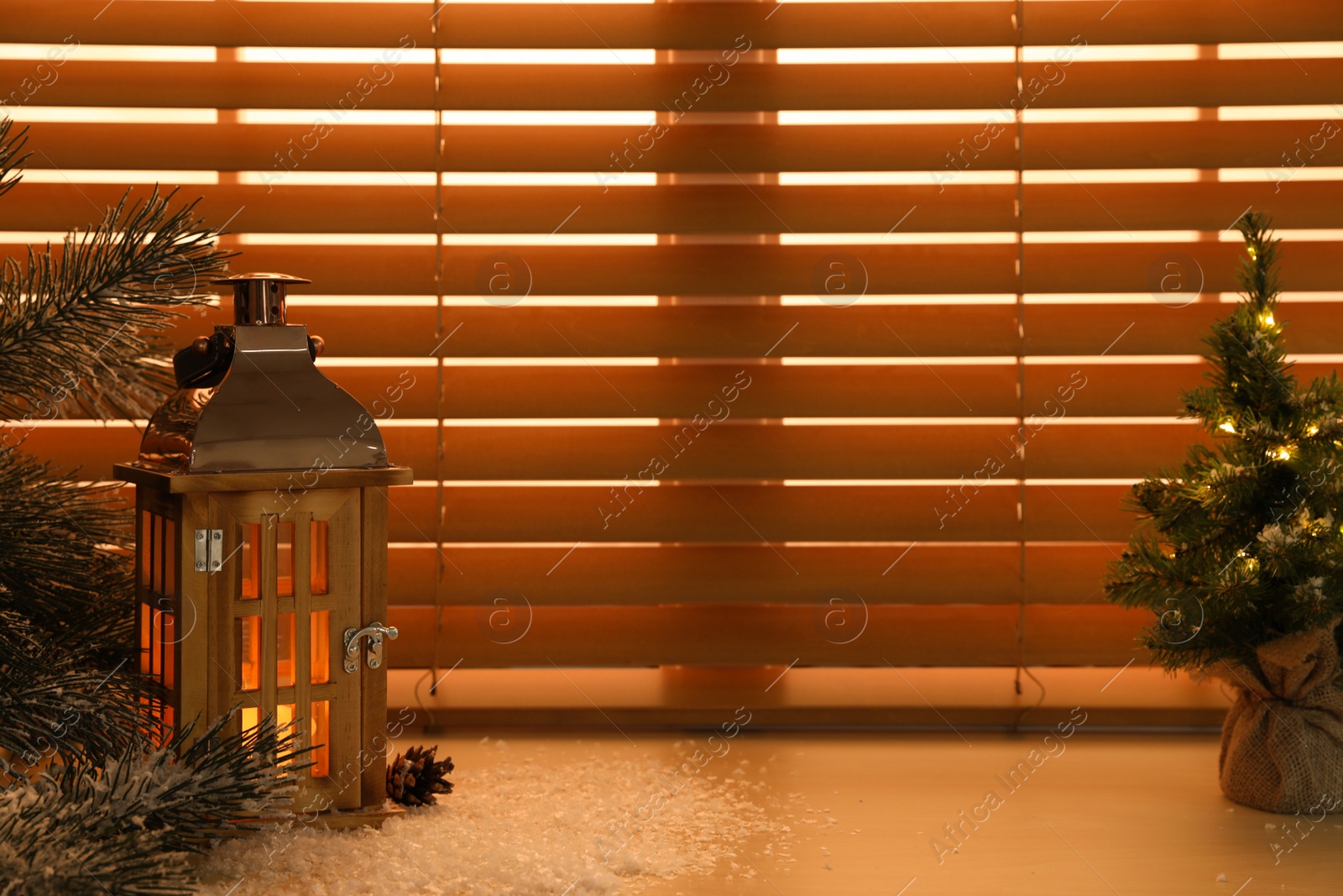 Photo of Beautiful decorative Christmas lantern with burning candle on window sill. Space for text