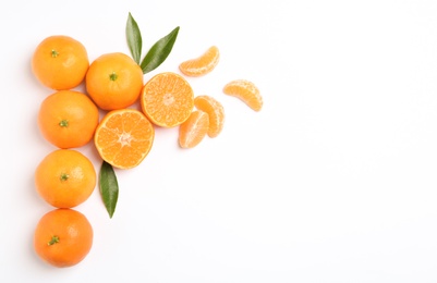 Composition with tangerines and leaves on white background, top view. Space for text