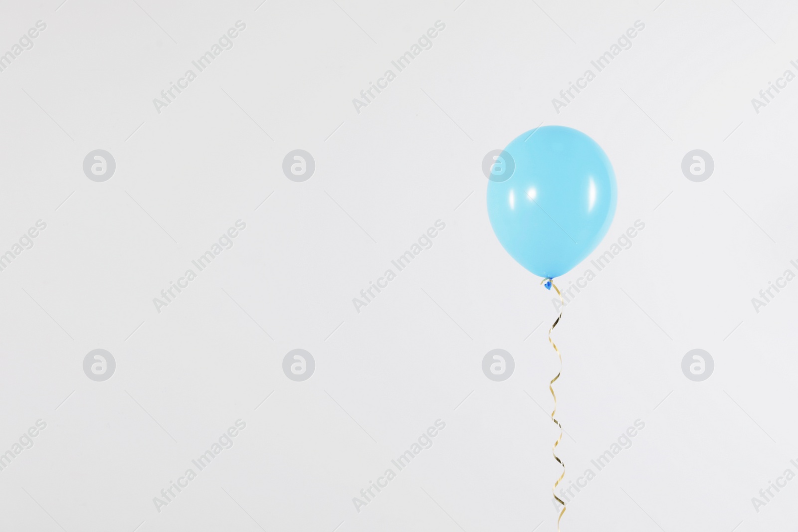 Photo of Bright balloon on light background, space for text. Celebration time