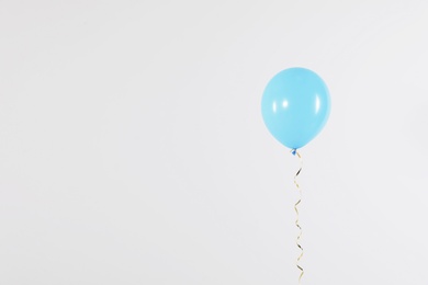 Bright balloon on light background, space for text. Celebration time