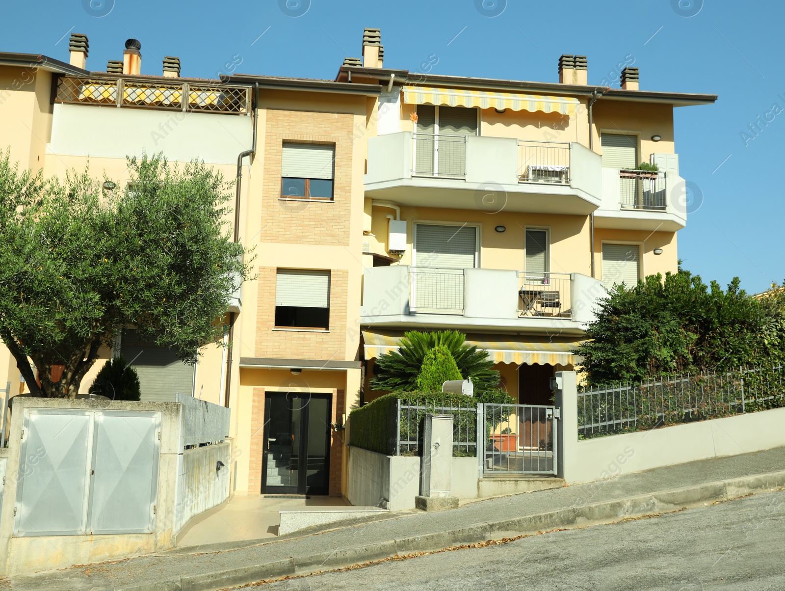 Photo of Modern residential building with balconies on sunny day