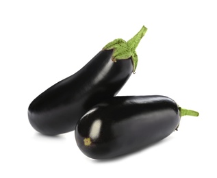 Photo of Tasty raw ripe eggplants on white background