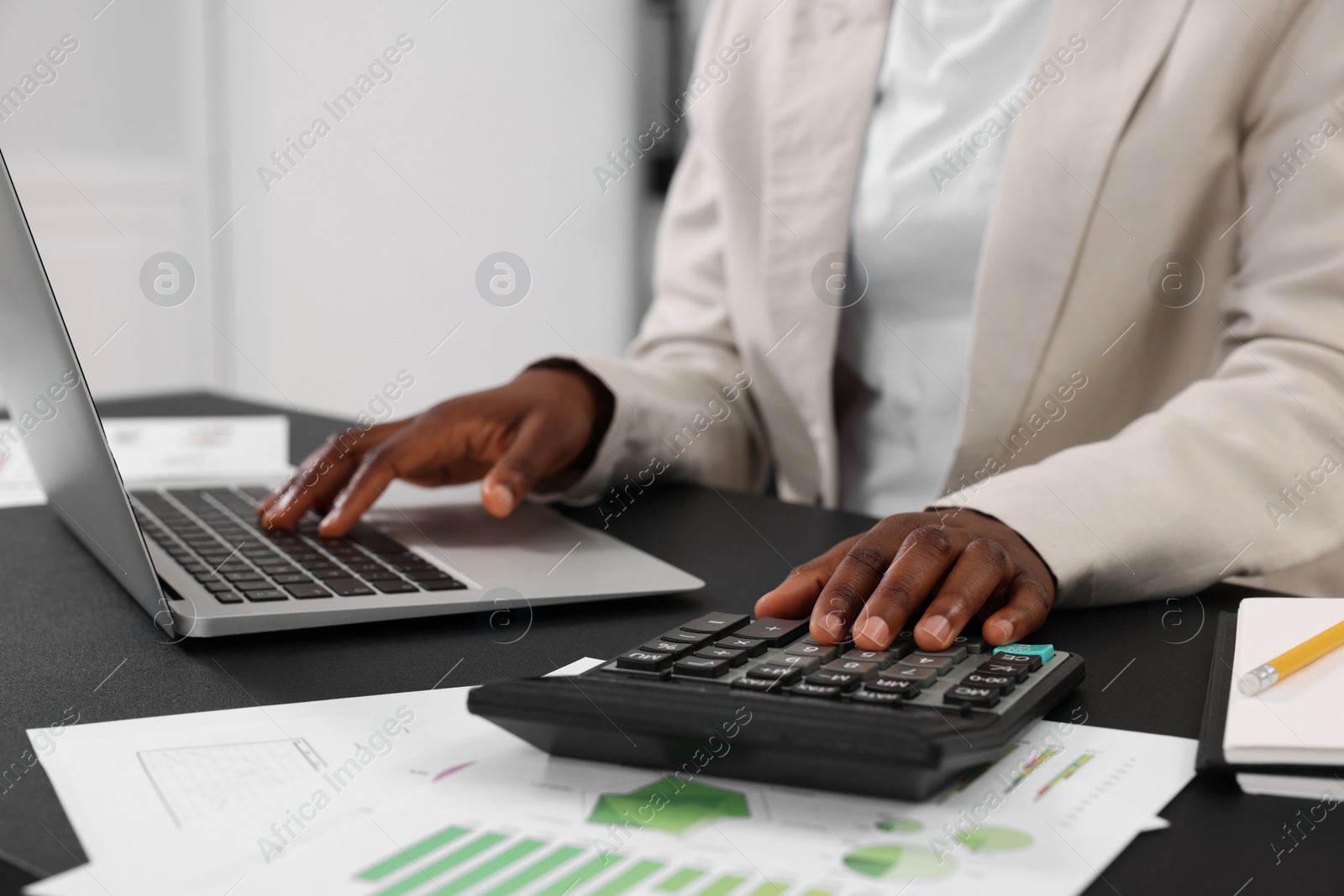 Photo of Professional accountant working at desk in office, closeup