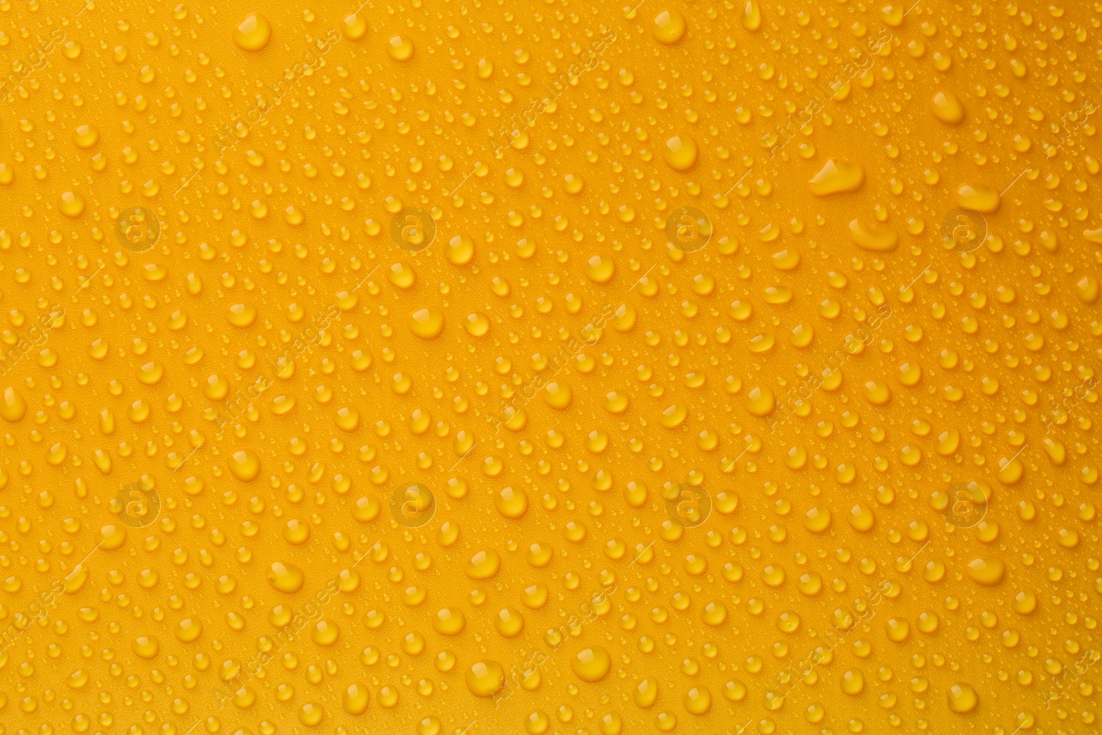 Photo of Water drops on orange background, top view