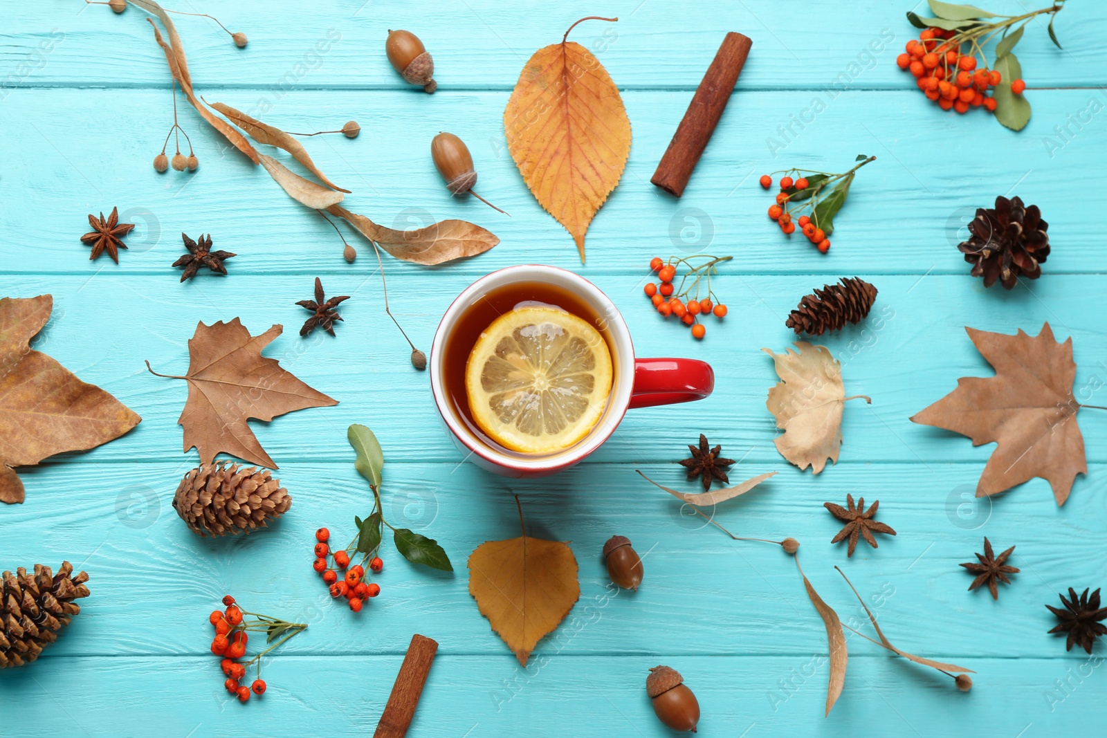 Photo of Flat lay composition with cup of hot drink on blue wooden table. Cozy autumn atmosphere