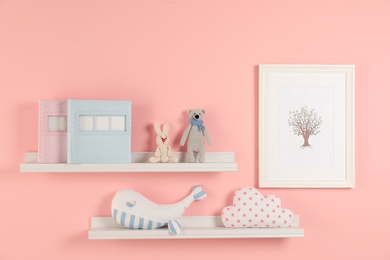 Photo of Toys and albums on shelves in child room