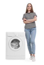 Beautiful young woman near washing machine with laundry on white background