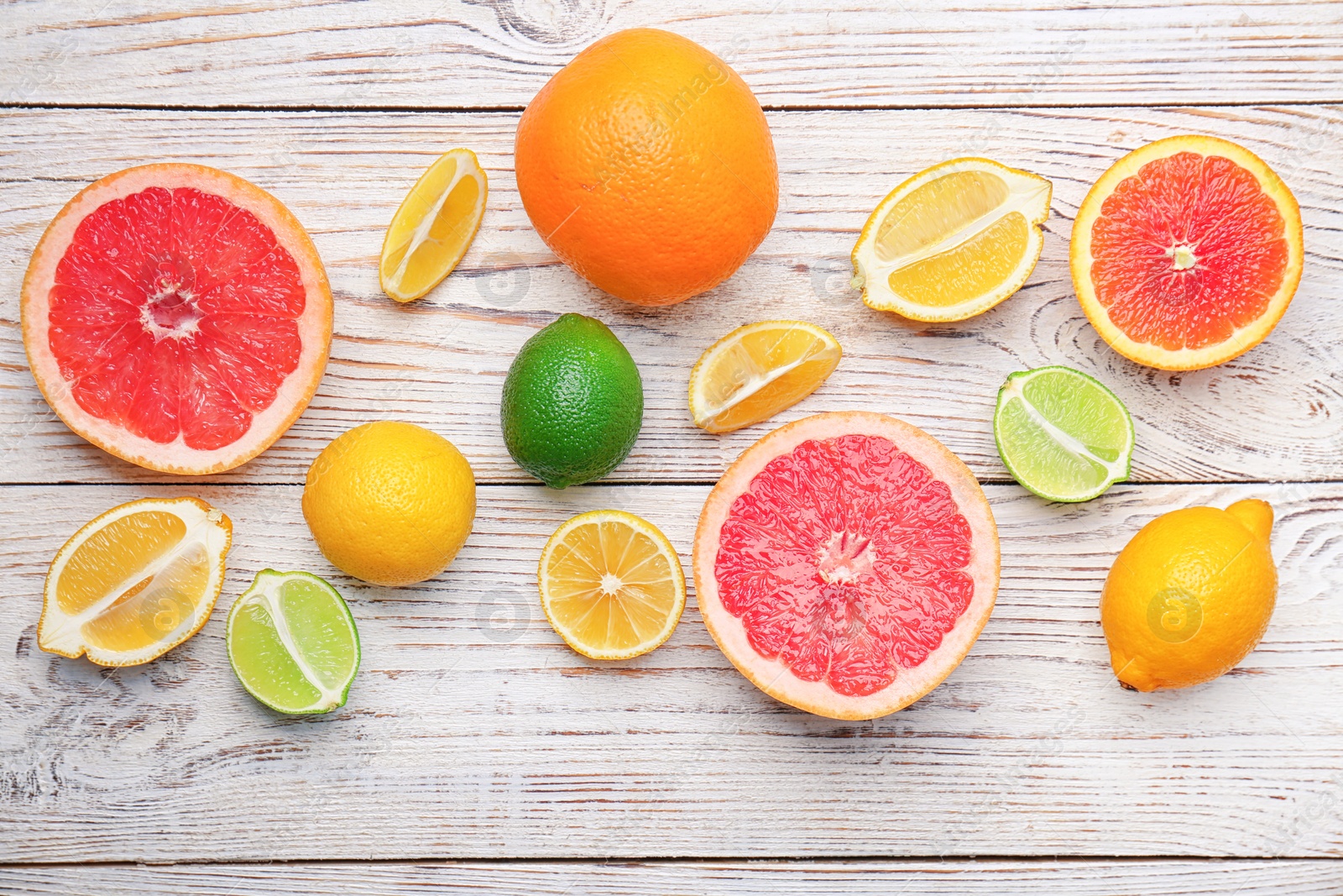 Photo of Many fresh citrus fruits on wooden table