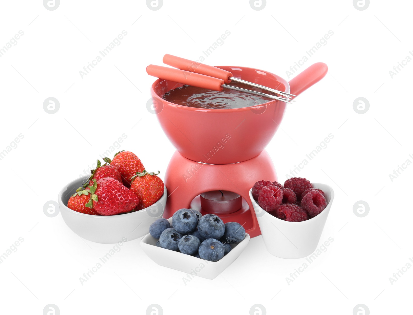 Photo of Fondue pot with melted chocolate, fresh berries and forks isolated on white