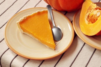 Photo of Plate with piece of fresh homemade pumpkin pie on table