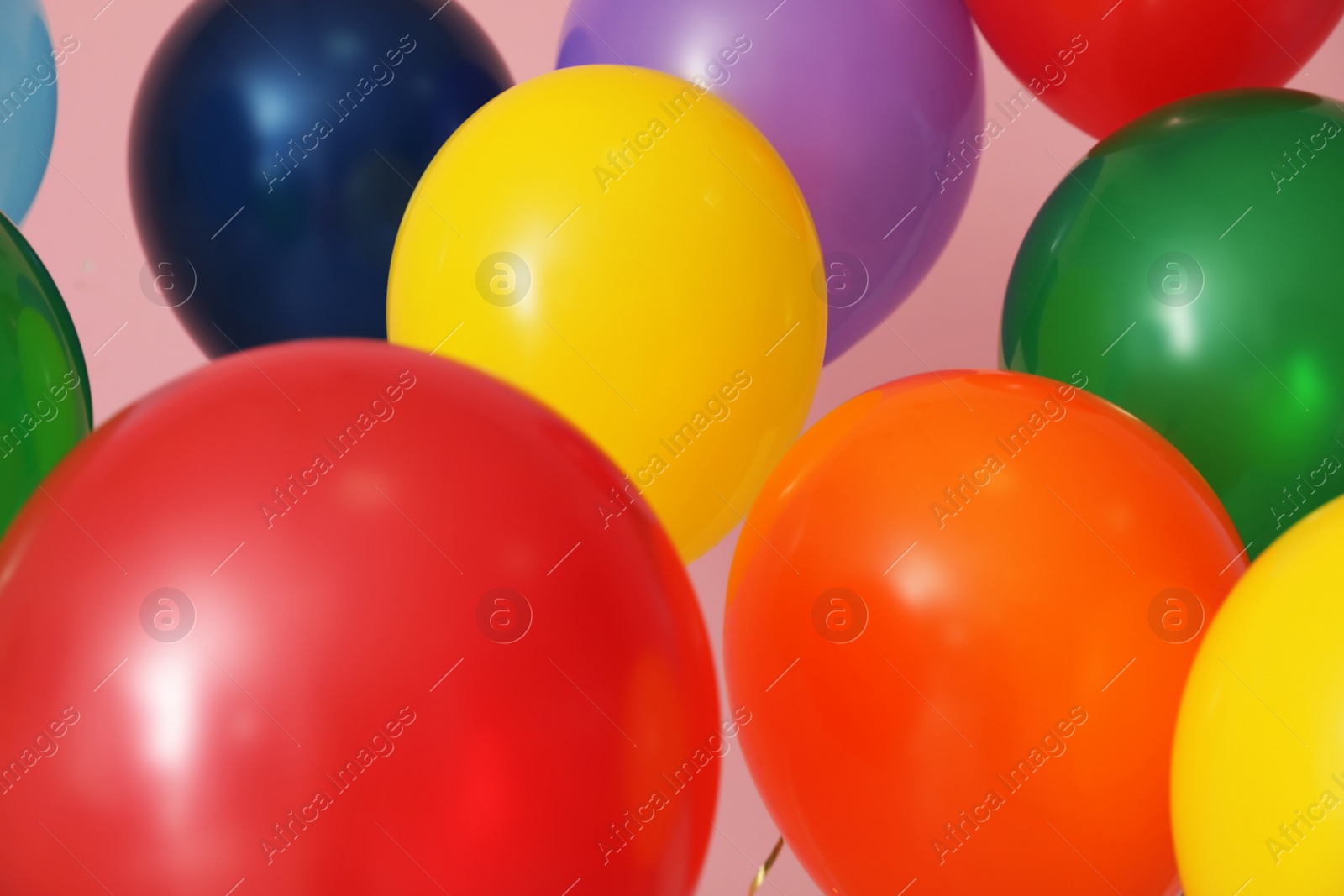 Photo of Bright balloons on color background. Celebration time