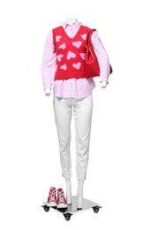 Photo of Female mannequin dressed in sweater vest, shirt and pants with bag and sneakers isolated on white. Stylish outfit