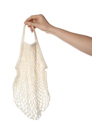 Photo of Woman holding eco friendly mesh bag on white background, closeup. Conscious consumption