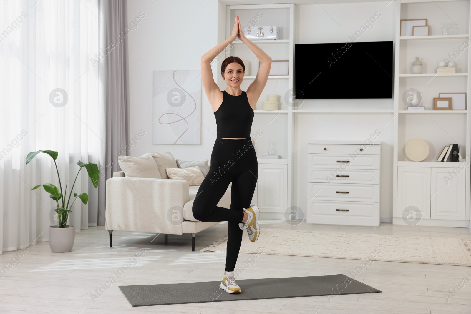 Photo of Happy woman doing morning exercise at home