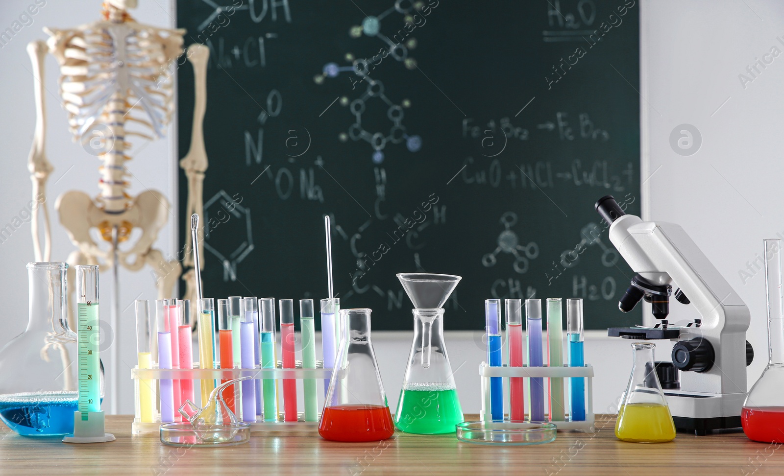 Photo of Different chemistry glassware on table in classroom