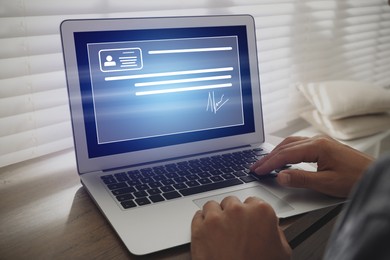 Image of Concept of electronic signature. Man working on laptop at wooden table indoors, closeup