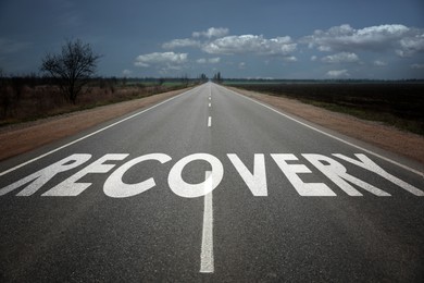 Image of Start to live without alcohol addiction. Word RECOVERY on asphalt highway