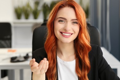 Photo of Happy woman having video call in office, view from web camera