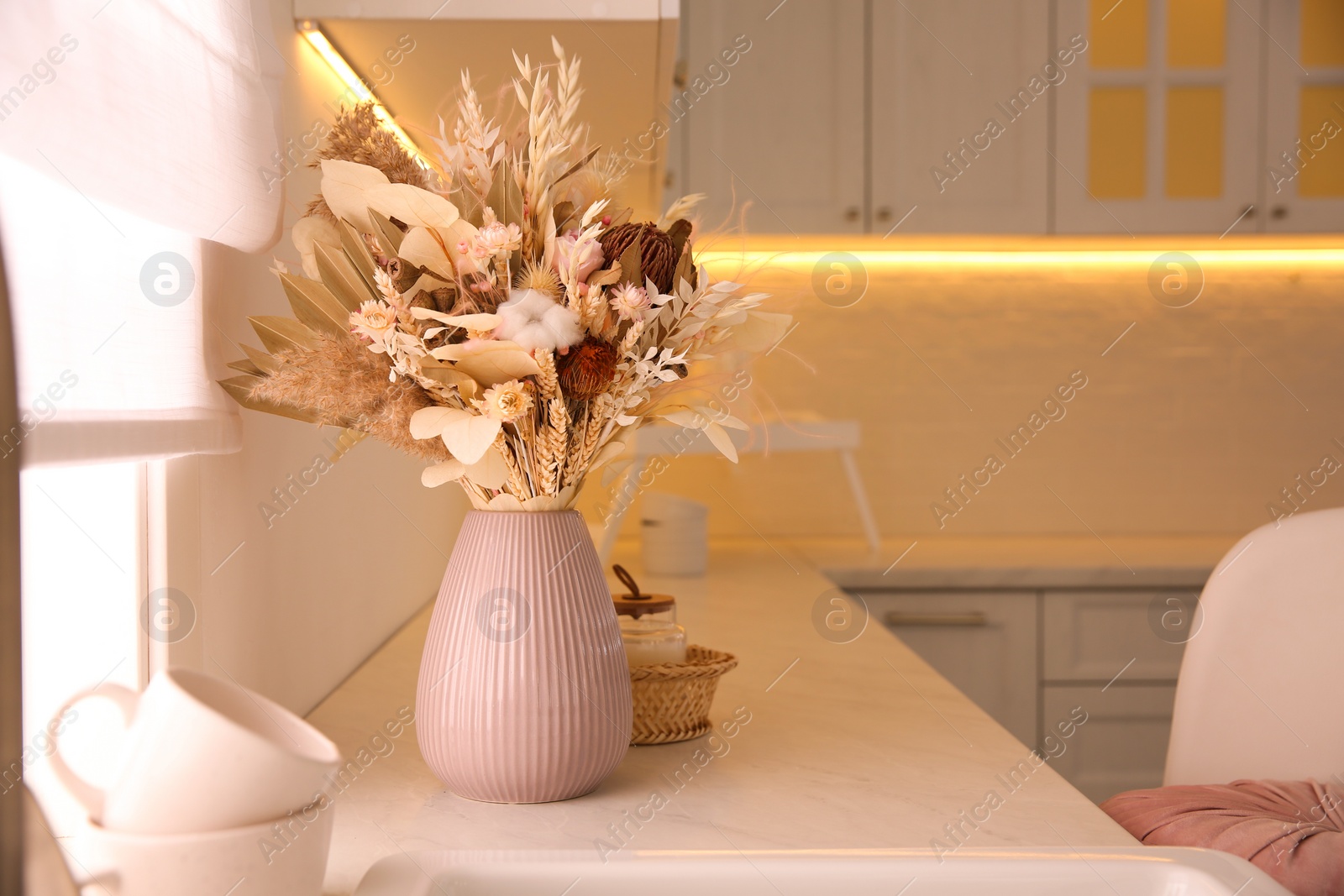 Photo of Bouquet of dry flowers and leaves on countertop in kitchen. Space for text