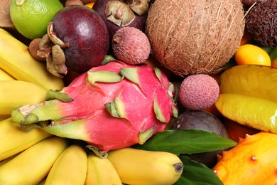 Different tropical fruits as background, closeup view