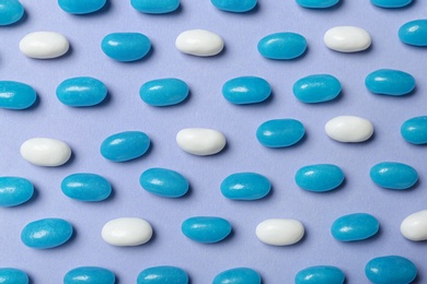 Many delicious jelly beans on color background, flat lay