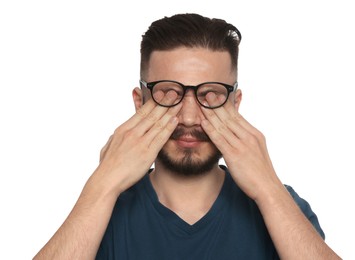 Young man suffering from eyestrain on white background