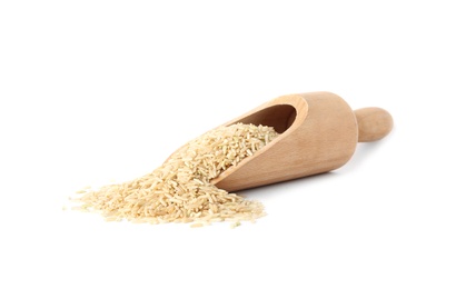 Photo of Scoop with uncooked brown rice on white background