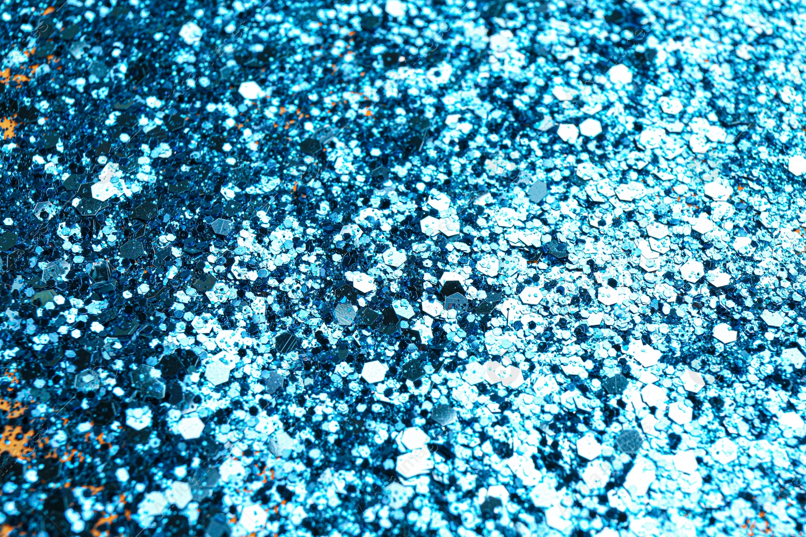 Photo of Shiny bright light blue glitter as background, closeup