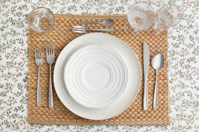 Stylish setting with cutlery, plates and glasses on table, top view