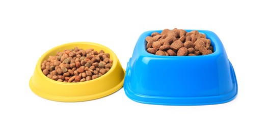 Photo of Dry pet food in feeding bowls isolated on white