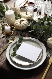 Photo of Beautiful autumn table setting with blank card and floral decor