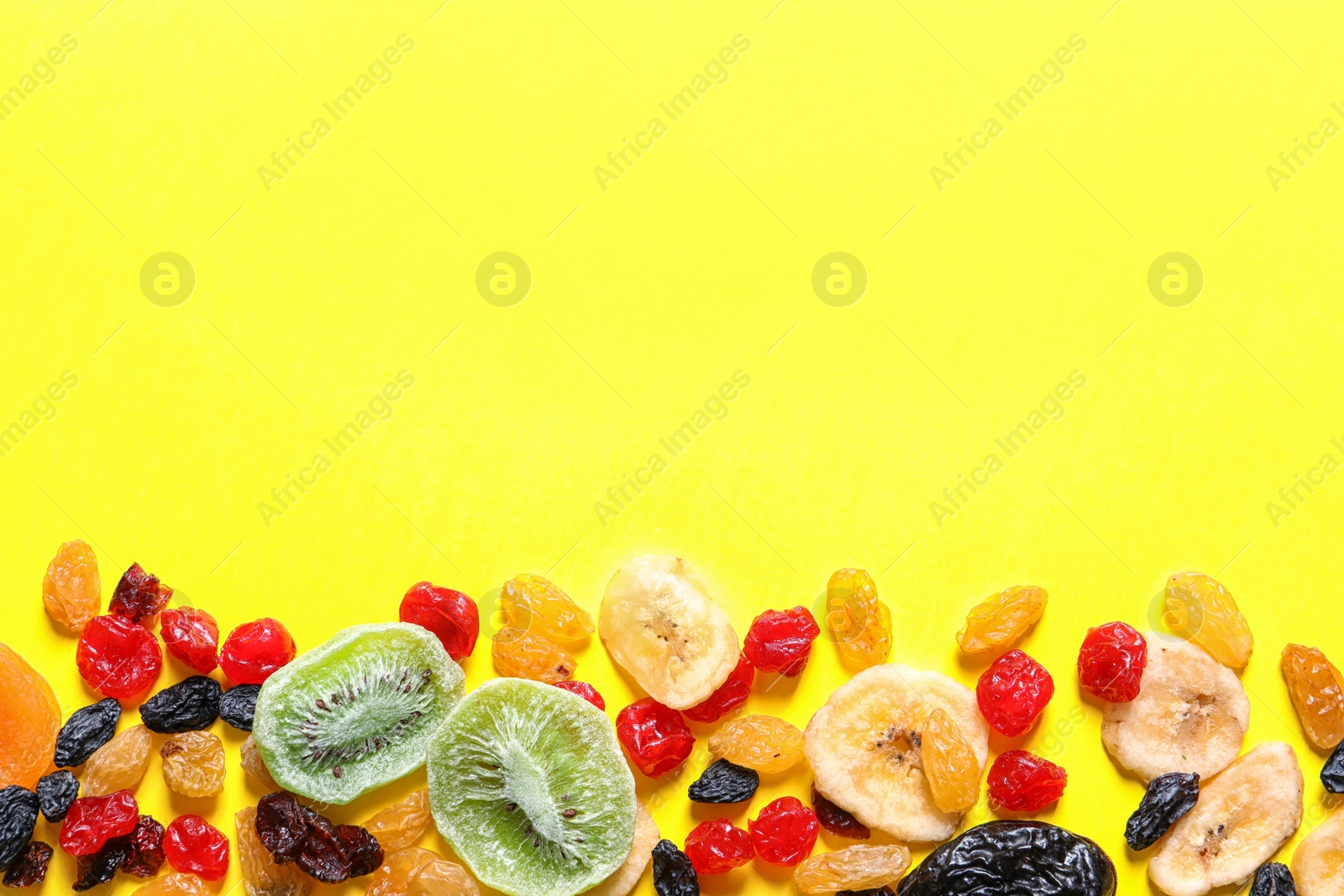 Photo of Different dried fruits on color background, top view with space for text. Healthy lifestyle