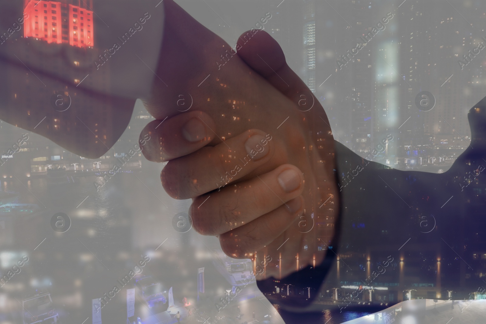 Image of Double exposure of partners shaking hands and cityscape