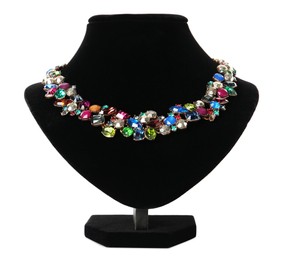 Photo of Stylish necklace with gemstones on jewelry bust against white background