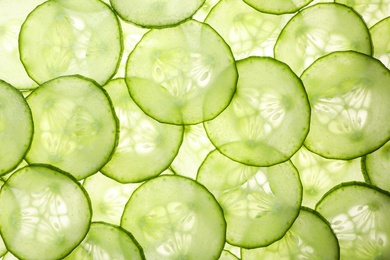 Photo of Slices of ripe cucumber as background, top view